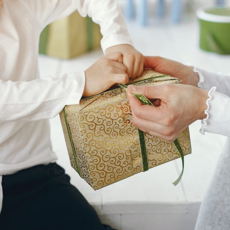 Mother with child. Family at home. People with presents.